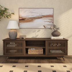 Mid-century modern wooden sideboard with decor items, including a ceramic lamp and abstract wall art, in a stylish living room setting.