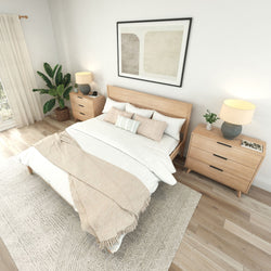 Modern neutral master bedroom interior with wooden platform bed, matching bedside dressers, beige layered bedding, bedside lamps, large abstract wall art, potted plant and hardwood floors in a minimalist Scandinavian style