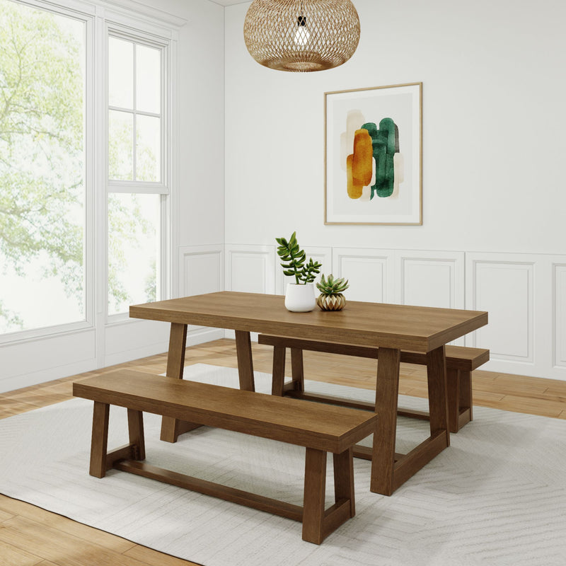 Rustic wooden dining table set with bench seating in modern minimalistic dining room with natural lighting and indoor plants.