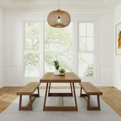 Dining room with modern wooden table and benches, featuring a decorative pendant light and potted plants by large windows.