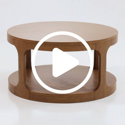Round wooden coffee table with lower storage shelf in natural oak finish, mid-century modern living room centerpiece.