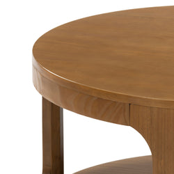 Round wooden coffee table with smooth finish and sturdy legs.