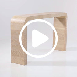 Modern light oak curved console table with rounded legs on white background with video play icon overlay