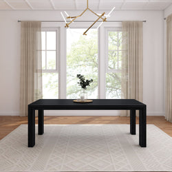 Modern dining room with a sleek black table, minimalist decor, and natural light.