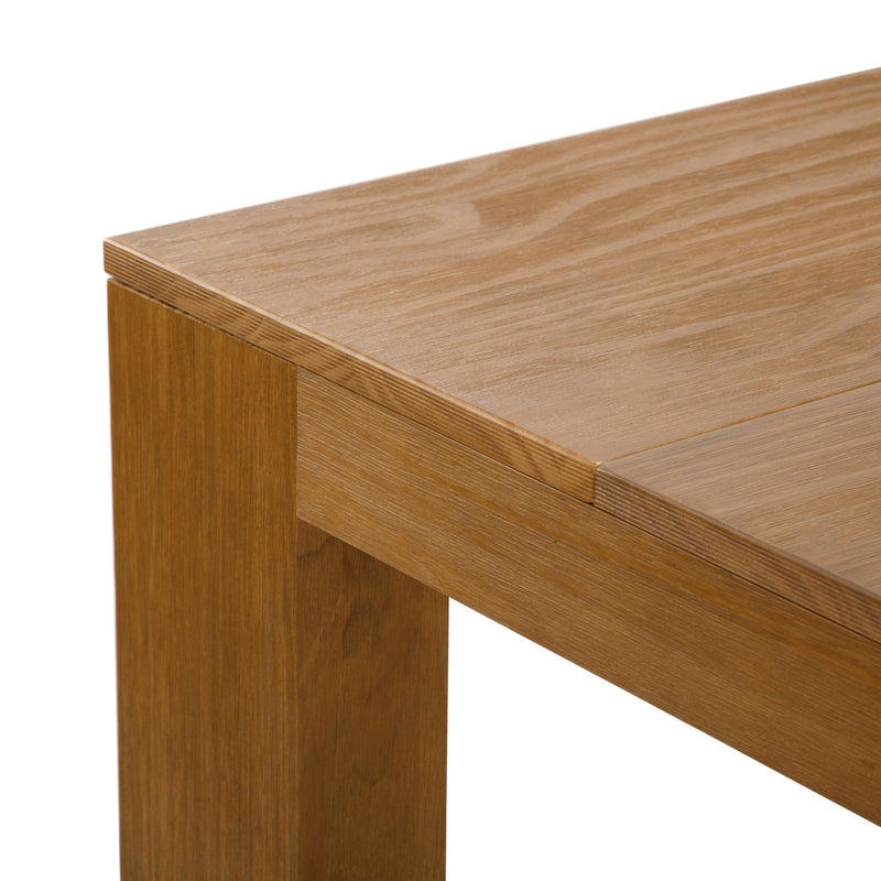 Close-up of solid oak dining table corner showing natural wood grain, light brown finish and sturdy square leg