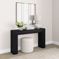 Modern foyer design with black console table, decorative lamp, mirror, and white stool.