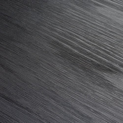 Textured black surface with diagonal lines creating a modern abstract pattern.