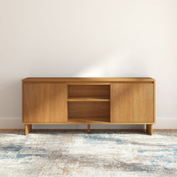 Mid-century modern light wood media console TV stand with cabinet doors and open shelving, minimalist living room storage on patterned area rug