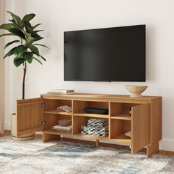 Wooden mid-century modern TV console with open shelving and cabinets under a wall-mounted flat-screen TV in a neutral living room with decorative storage boxes and potted plant