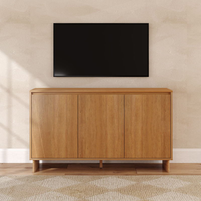 Minimalist living room with wall-mounted flat-screen TV above a mid-century oak media console against a beige textured wall on hardwood floor
