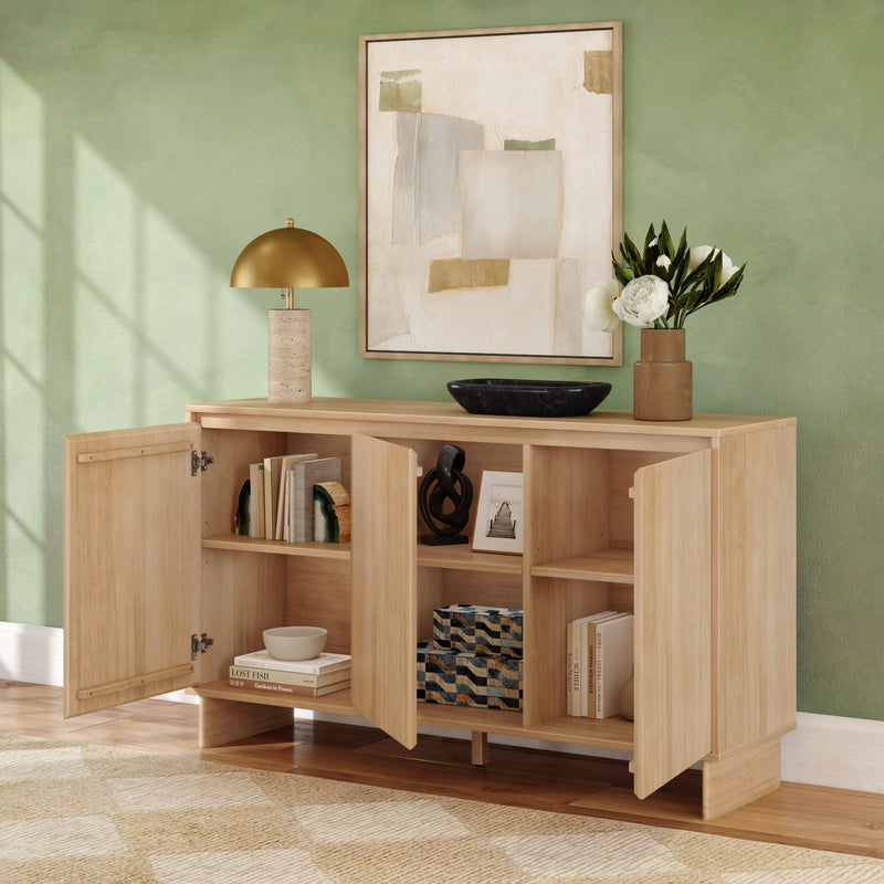 Natural wood modern sideboard with open cabinet doors, storage shelves, brass dome lamp, abstract wall art and vase of white flowers against a green wall