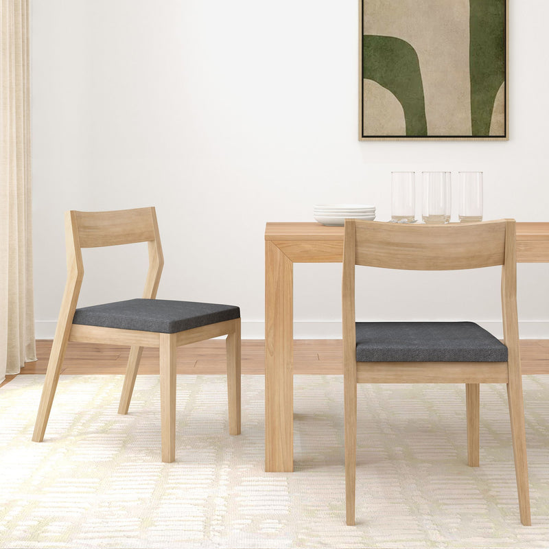 Modern dining room with wooden chairs and a minimalist table setting.