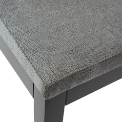 Gray upholstered seat cushion on black wooden chair.