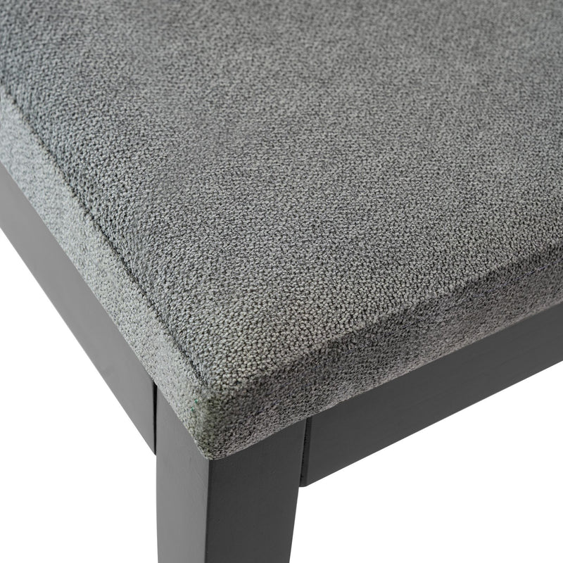Gray upholstered seat cushion on black wooden chair.