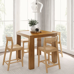 Modern dining room with wooden table and chairs, featuring decorative centerpiece and pendant light.