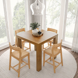 Cozy dining room with a wooden table and four chairs, round rug, and a modern pendant light near large windows.