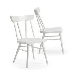 White wooden farmhouse-style chairs with spindle backs, ideal for rustic dining room decor.