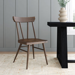 Modern wooden chair beside a minimalist dining table in a stylish room setting.