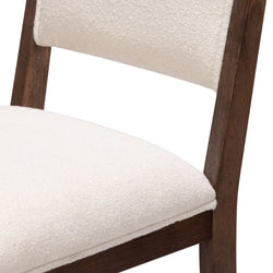 Modern wooden chair with white cushioned seat and backrest.