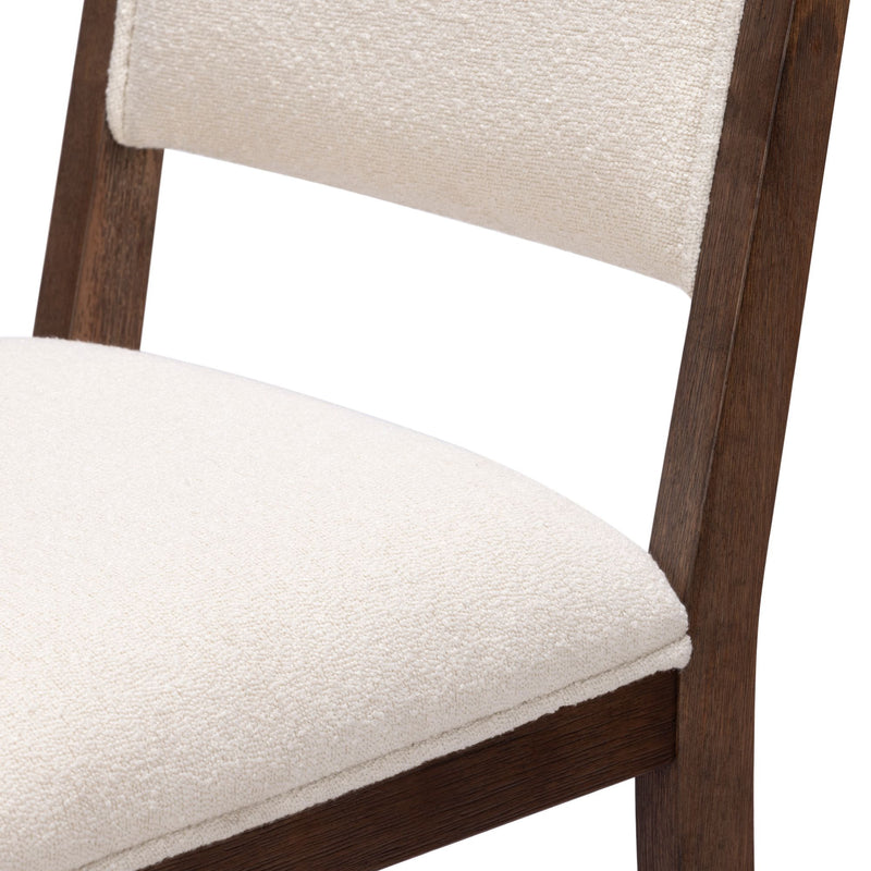 Modern wooden chair with white cushioned seat and backrest.
