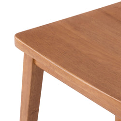 Wooden table corner with smooth finish and sturdy leg design.