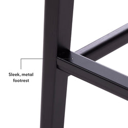 Close-up of a sleek, metal footrest on a modern stool design.