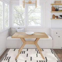 Eco-friendly wooden dining table in modern kitchen with minimalist decor and natural light from large windows.
