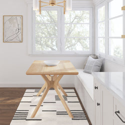 Modern dining area with a wooden table, minimalist decor, and large windows.