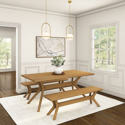 Modern dining room with wooden table and benches, abstract wall art, and elegant pendant lights.