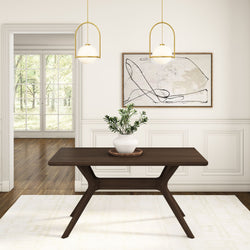 Modern dining room with wooden table, potted plant centerpiece, contemporary artwork, and pendant lighting.