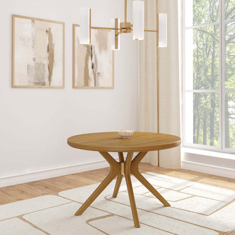 Modern round wooden dining table with decorative bowl in bright minimalist room with abstract paintings and large window.