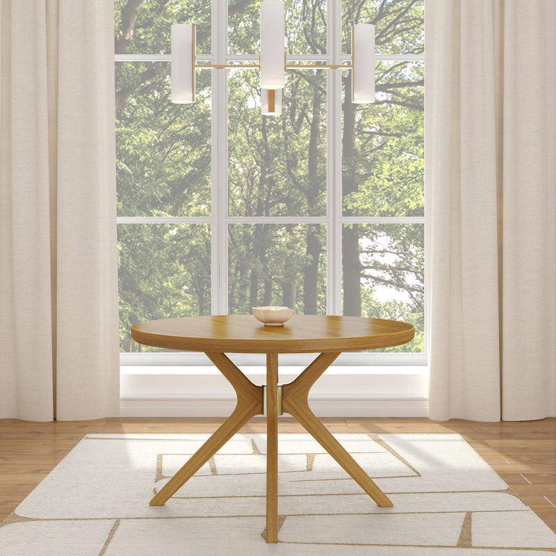 Modern round wooden table in a bright room with large window and elegant chandelier.