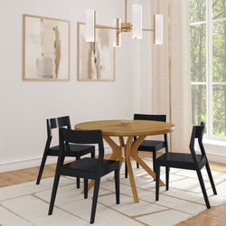 Modern dining room with wooden round table, black chairs, abstract wall art, and contemporary lighting.
