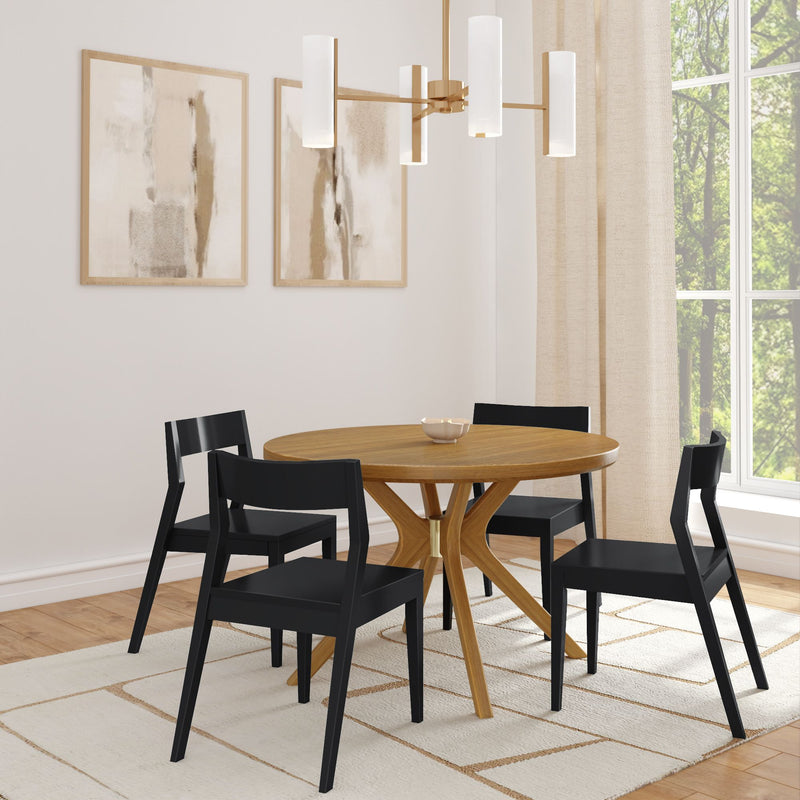 Modern dining room with wooden round table, black chairs, abstract wall art, and contemporary lighting.