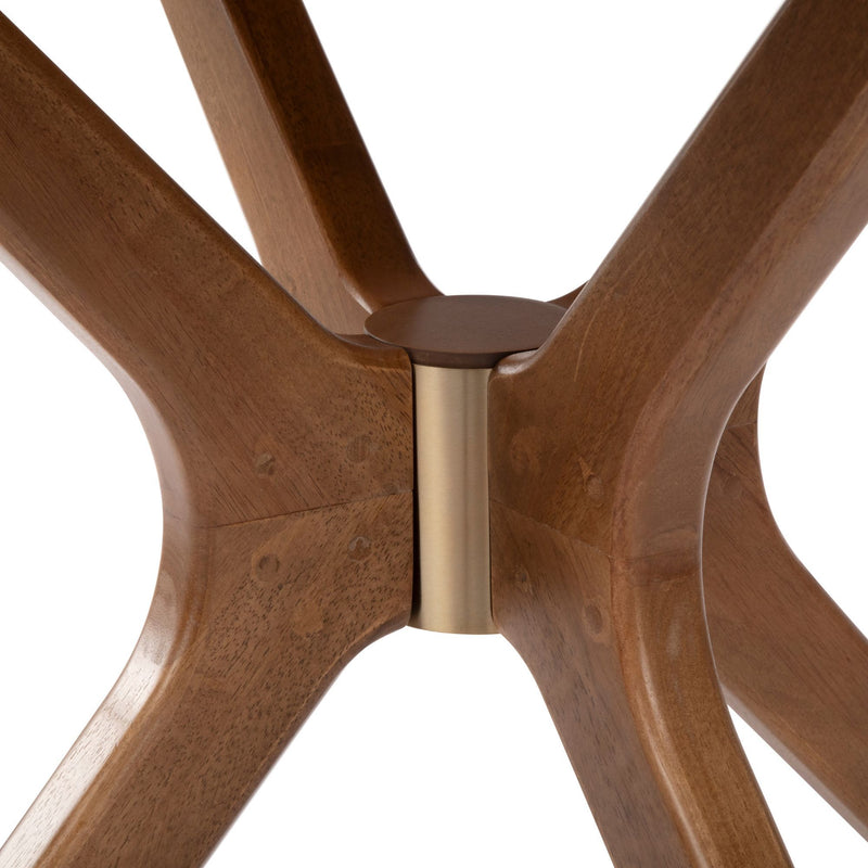 Modern wooden table leg design with brass accent, close-up view.