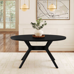 Modern black dining table in elegant living room with minimalist decor and abstract wall art.
