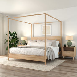 Light wood four‑poster canopy bed in a minimalist Scandinavian master bedroom with neutral bedding, matching nightstands, green lamps, indoor plant, and hardwood floors
