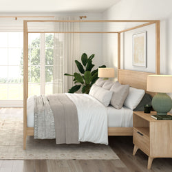 Bright Scandinavian minimalist bedroom with wooden four-poster canopy bed, neutral linen bedding, potted plant, wooden nightstand and lamps by large window