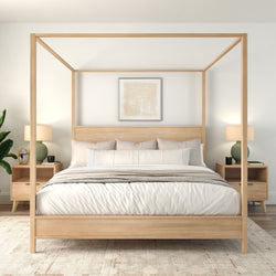 Modern minimalist bedroom with light-wood four-poster canopy bed, neutral linens, matching nightstands with lamps and a potted plant