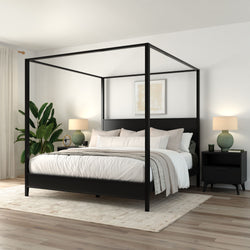 Black four-poster canopy bed in modern minimalist bedroom with neutral linen bedding, black nightstands, table lamps, indoor plant and wood flooring