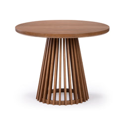 Round wooden dining table with slatted pedestal base on white background.