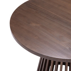 Round wooden table with smooth finish and slatted base design.