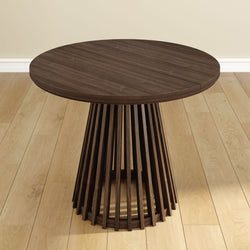 Round wooden table with slatted design on a light hardwood floor, ideal for modern home interiors.