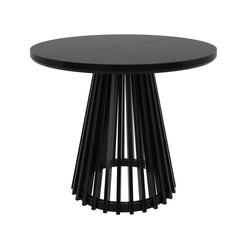 Modern black round dining table with unique geometric metal base design.