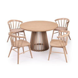 Contemporary round wooden dining table with four matching chairs, perfect for modern home decor.