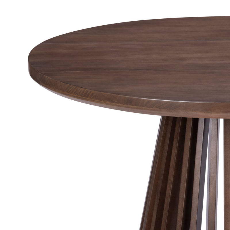 Close-up of a round walnut-finish wooden dining table showing a smooth solid wood tabletop and slatted pedestal base