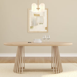 Modern Scandinavian dining room with light wood oval table and slatted pedestal base, neutral beige walls, abstract framed art, pendant light, stacked plates and two wine glasses