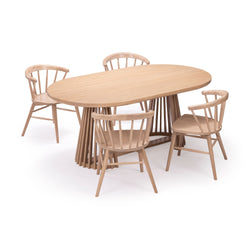Oval oak dining table set with four spindle-back chairs, Scandinavian light natural wood finish, slatted pedestal base, modern minimalist dining furniture on white background