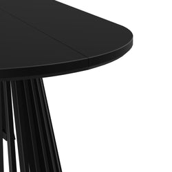 Close-up of matte black round dining table edge and center seam with fluted pedestal base