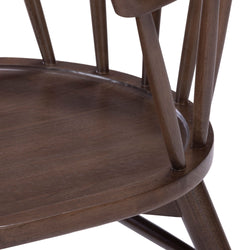 Elegant wooden chair with curved backrest and spindle design, perfect for dining or living room furniture.